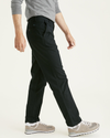 Side view of model wearing Mineral Black Original Chinos, Straight Fit.