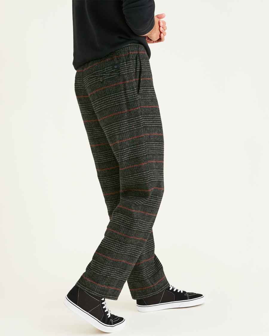 Side view of model wearing Mineral Black Pull On Chinos, Tapered Fit.