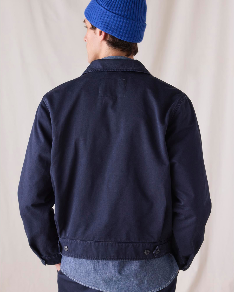 Back view of model wearing Navy Blue Dockers® x Transnomadica Mechanics Jacket, Regular Fit.