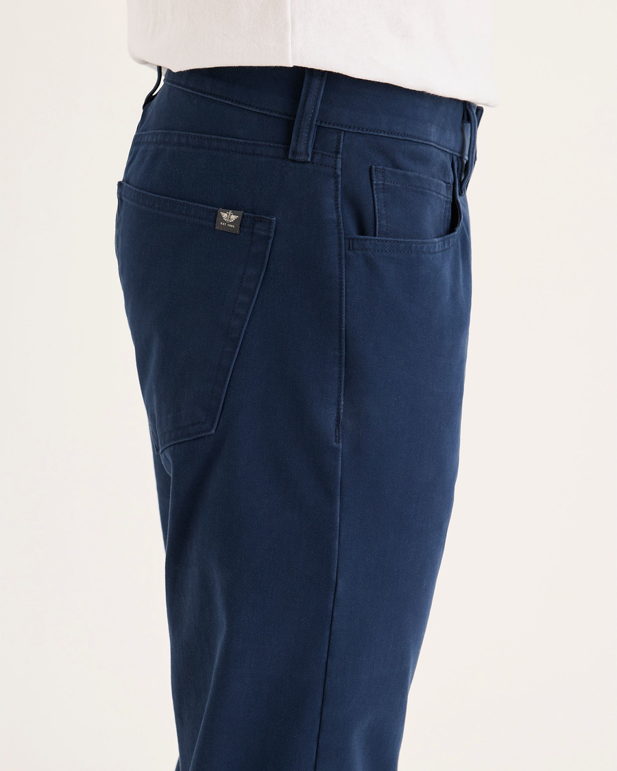 Side view of model wearing Navy Blazer All-Day 5-Pocket, Slim Fit.