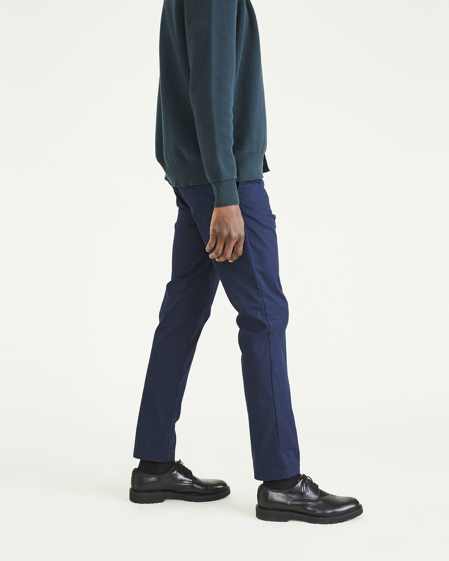 Side view of model wearing Navy Blazer Coast Trousers, Slim Fit.