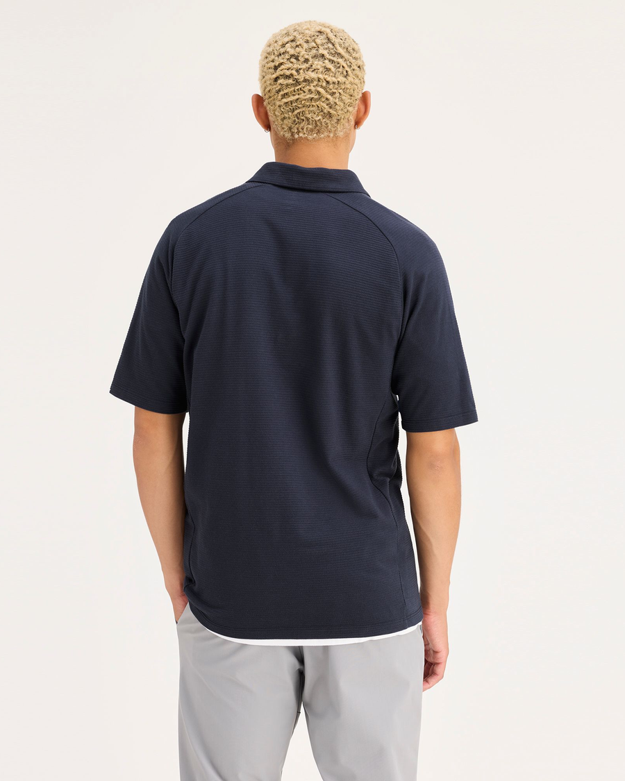 Back view of model wearing Navy Blazer Go Raglan Polo, Regular Fit.