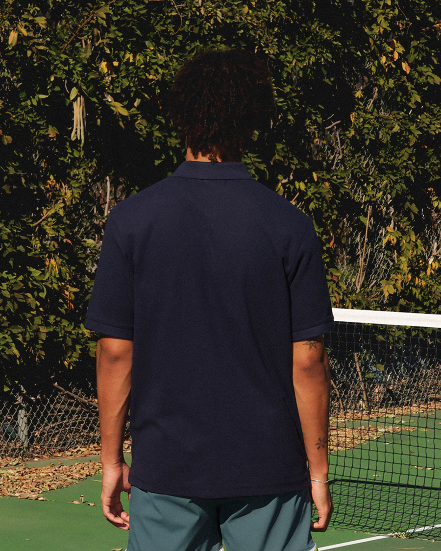 View of model wearing Navy Blazer Racquet Club Polo, Regular Fit.