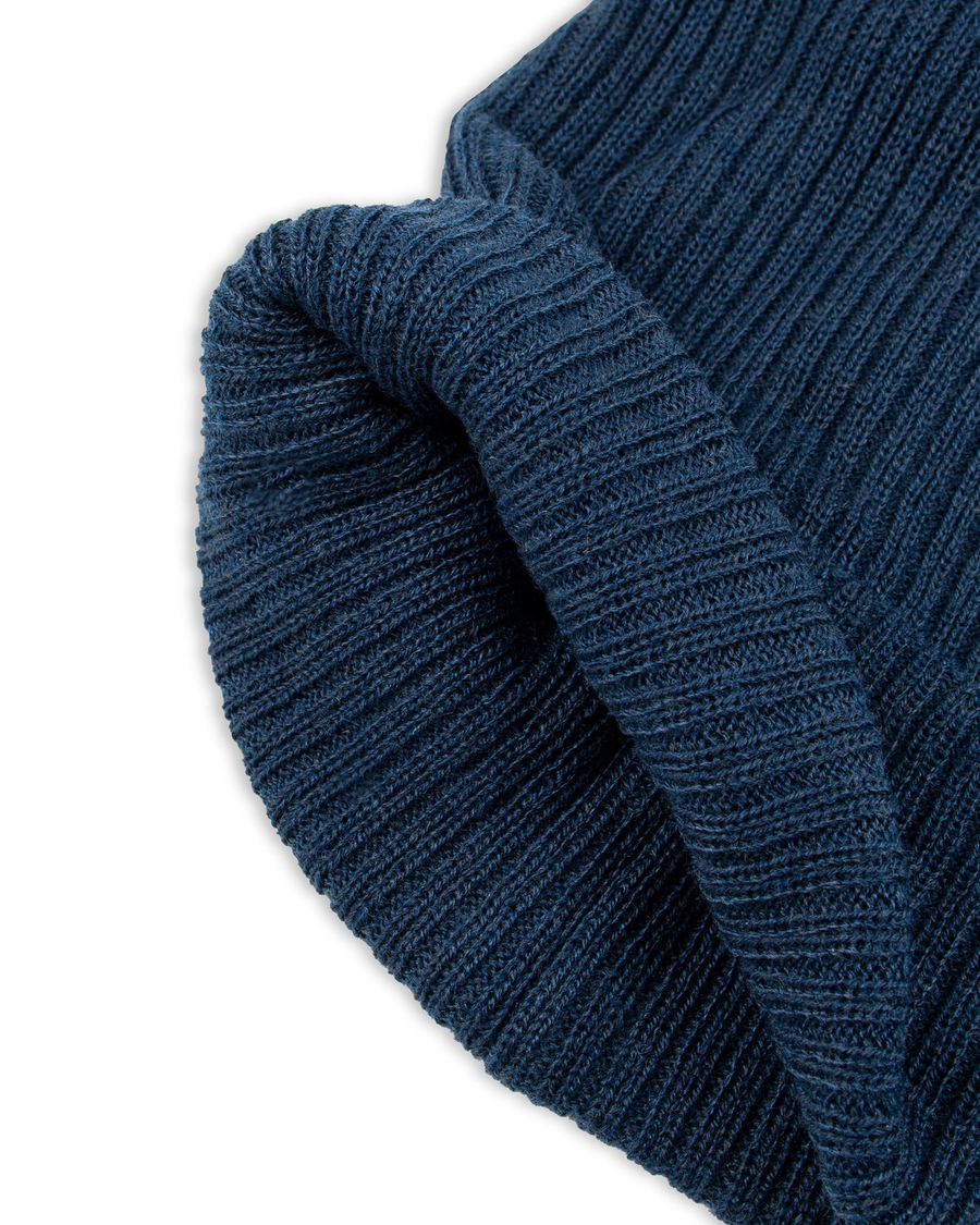 View of  Navy Recycled Double Knit Ribbed Beanie w/ Woven Seasonal Graphic.