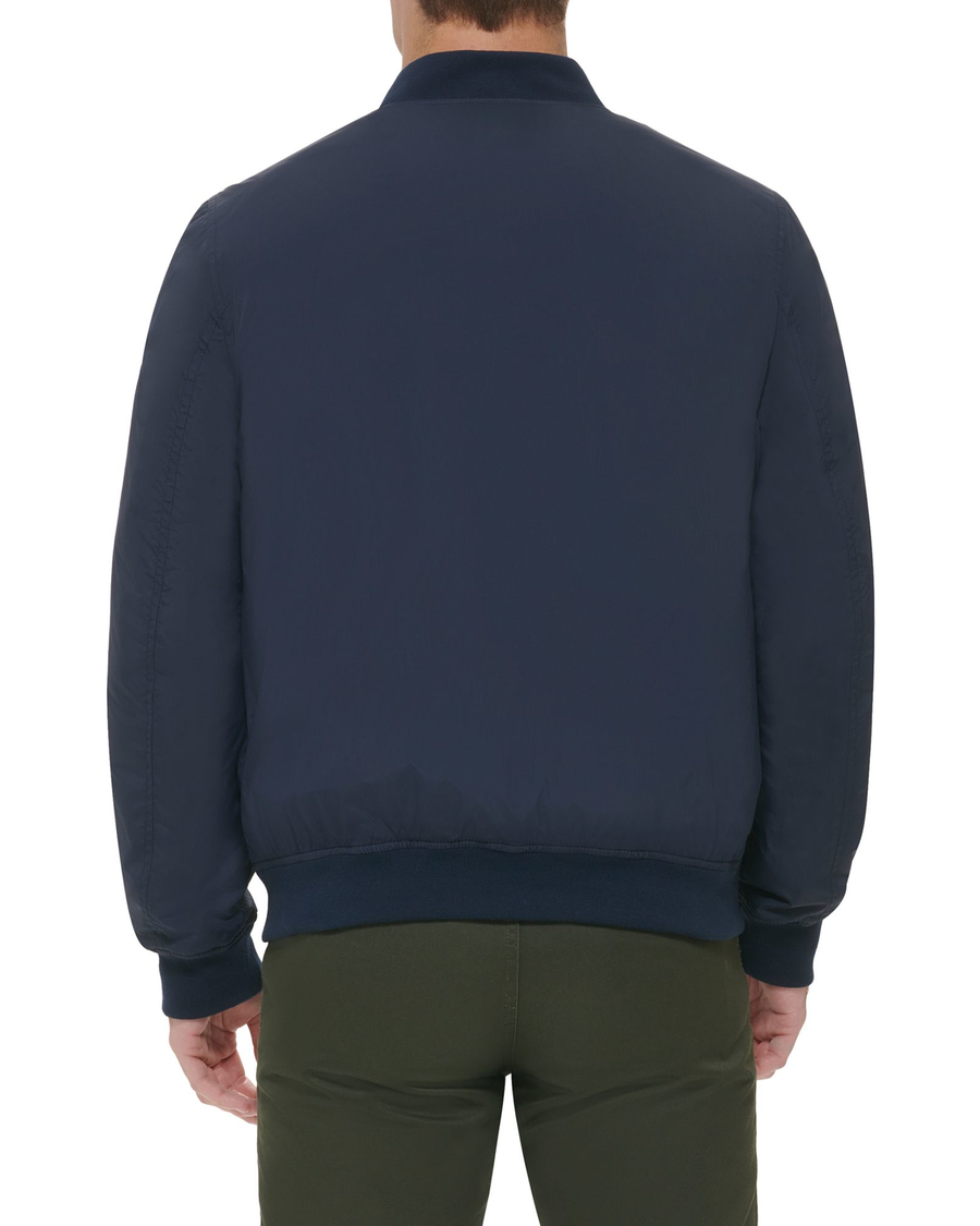 Back view of model wearing Navy Recycled Dry Touch Nylon Bomber.