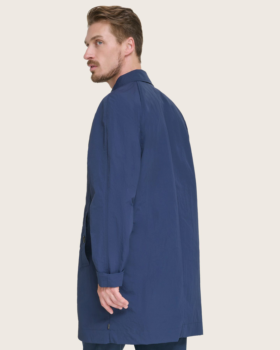 Back view of model wearing Navy Sail Cloth Trench Coat.