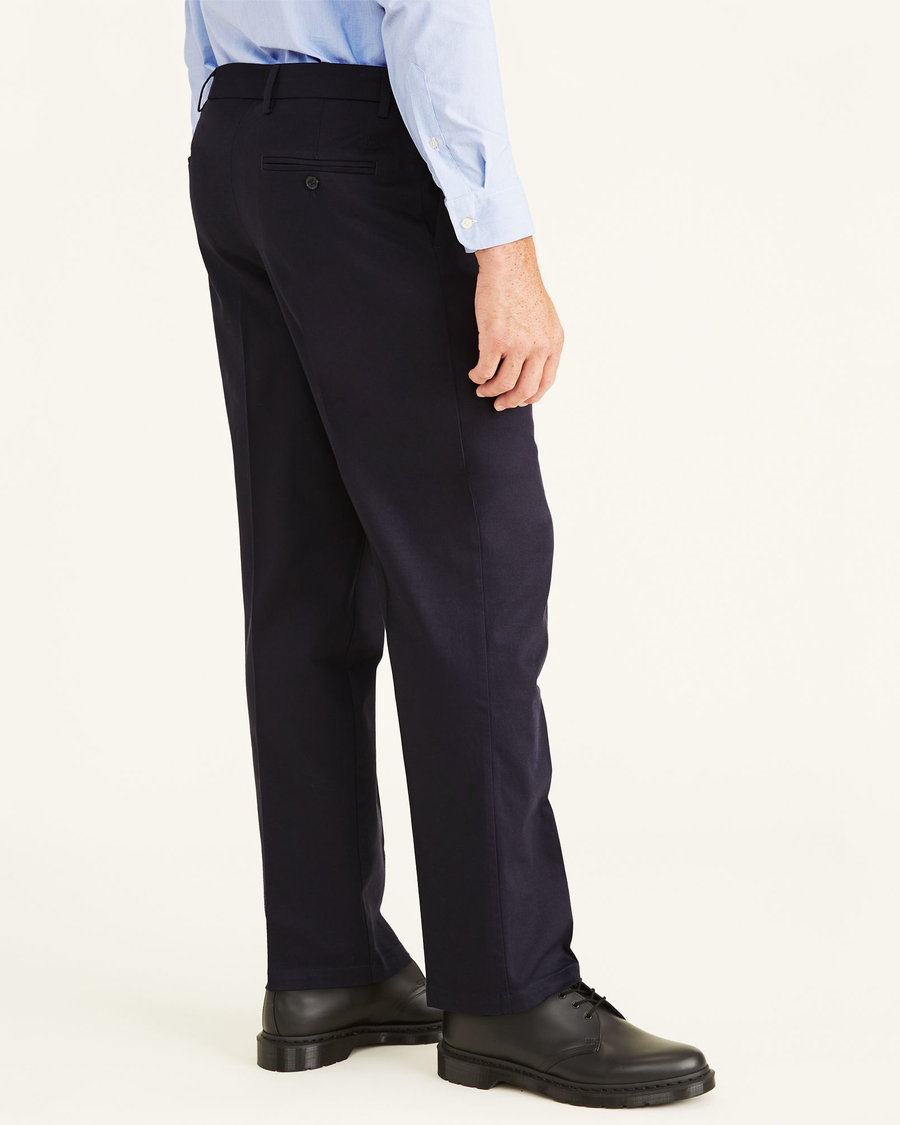 Side view of model wearing Navy Signature Khakis, Pleated, Classic Fit (Big and Tall).