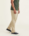 Side view of model wearing New British Khaki Jean Cut Pants, Athletic Fit.