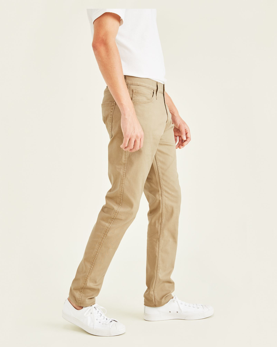 Side view of model wearing New British Khaki Jean Cut Pants, Slim Fit.