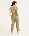 Back view of model wearing New British Khaki Original Khakis, Pleated, High Waisted Tapered Fit.
