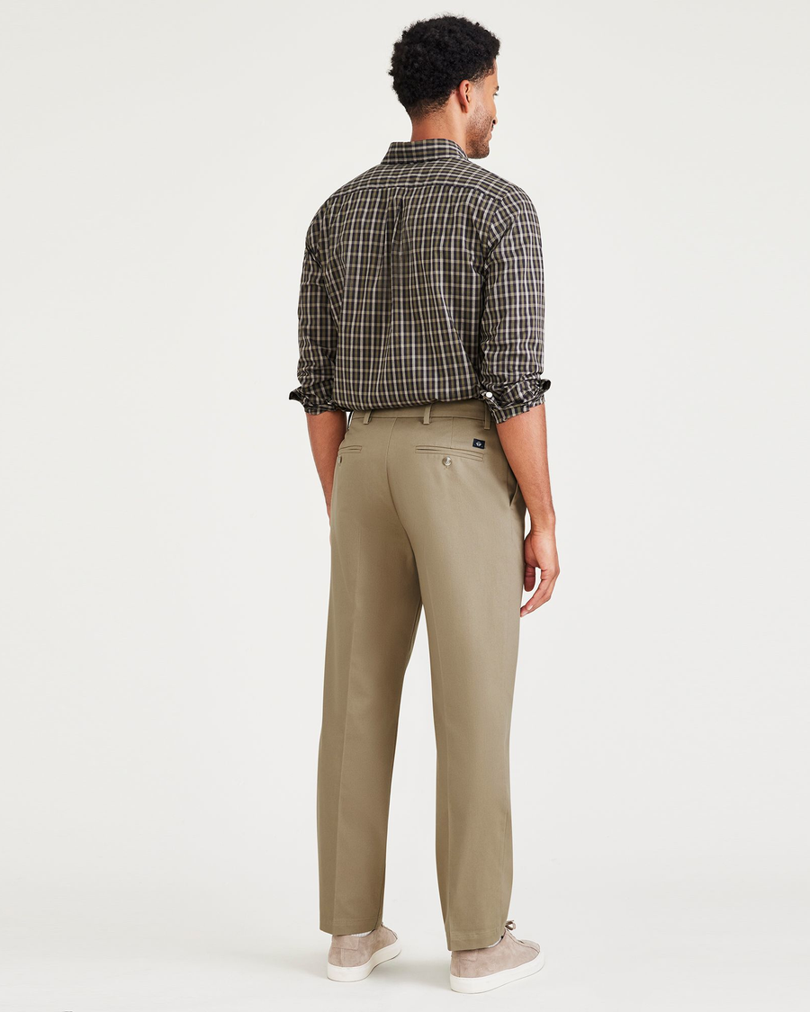 Back view of model wearing New British Khaki Signature Iron Free Khakis, Pleated, Classic Fit with Stain Defender® (Big and Tall).