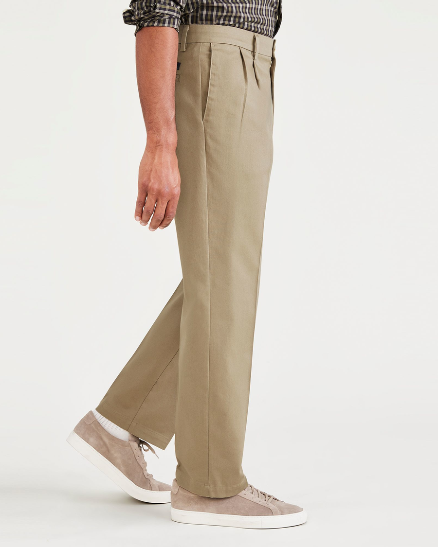 Side view of model wearing New British Khaki Signature Iron Free Khakis, Pleated, Classic Fit with Stain Defender® (Big and Tall).