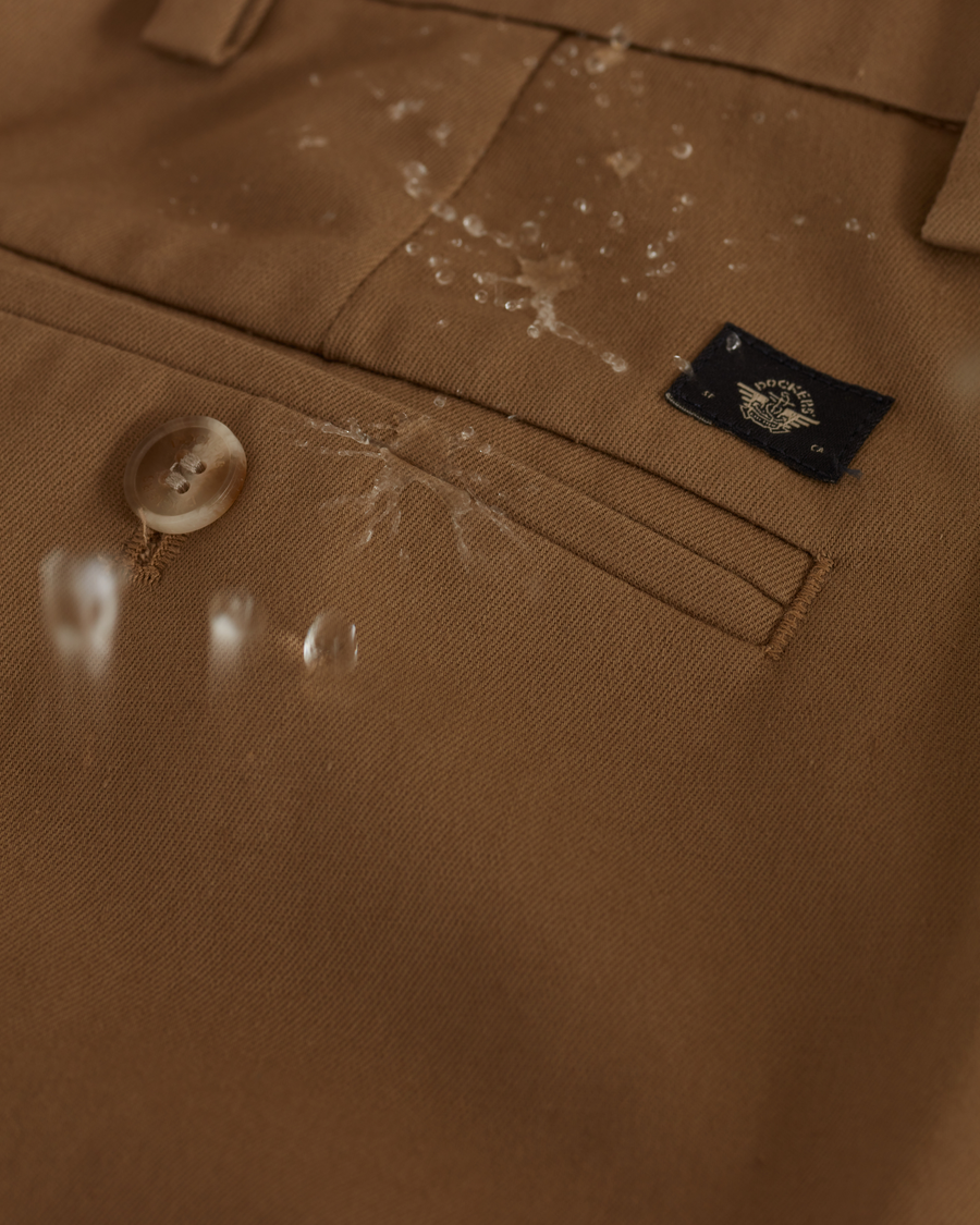 View of model wearing New British Khaki Signature Iron Free Khakis, Pleated, Relaxed Fit with Stain Defender®.
