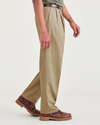 Side view of model wearing New British Khaki Signature Iron Free Khakis, Pleated, Relaxed Fit with Stain Defender®.