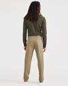 Back view of model wearing New British Khaki Signature Iron Free Khakis, Slim Fit with Stain Defender®.