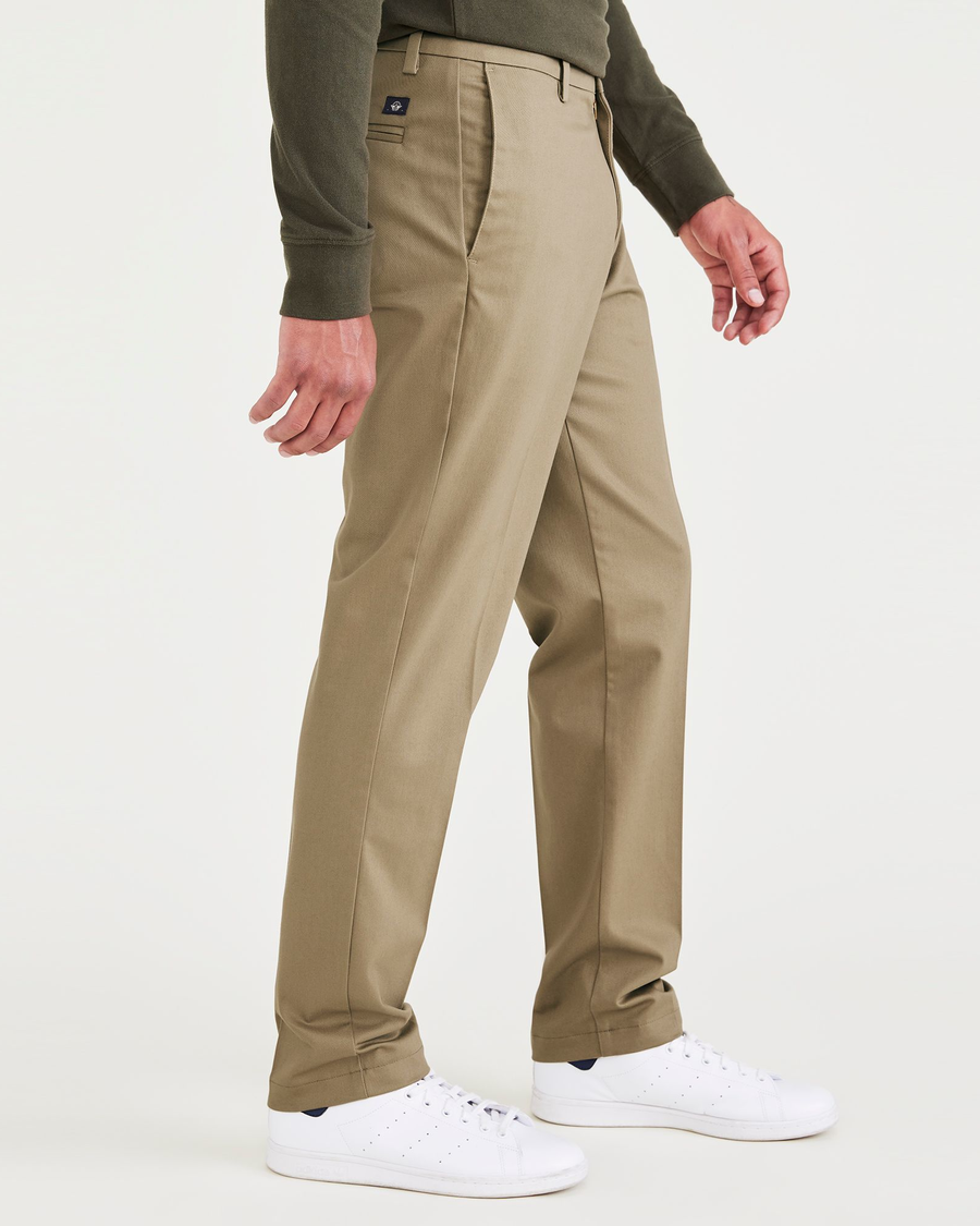 Side view of model wearing New British Khaki Signature Iron Free Khakis, Slim Fit with Stain Defender®.