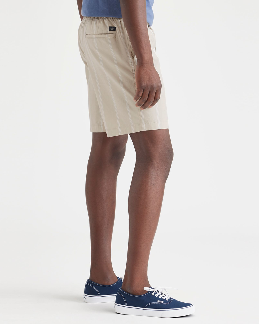 Side view of model wearing Nomad Sahara Khaki Ultimate Pull On 9.5" Shorts.