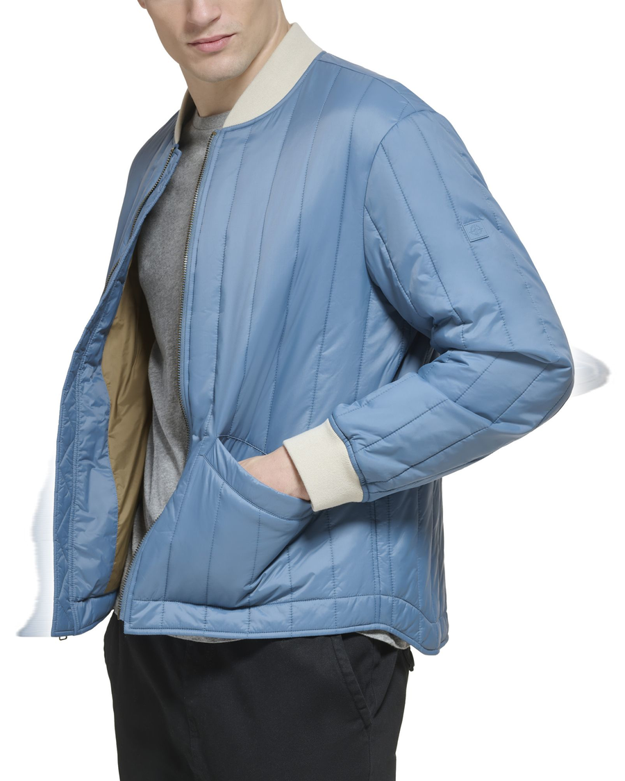 Side view of model wearing Oceanview Recycled Nylon Channel Quilted Bomber Jacket.