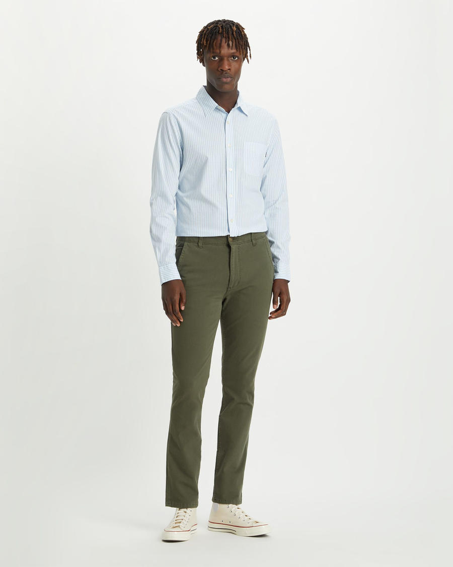 Front view of model wearing Olive Alpha Khakis, Skinny Fit.