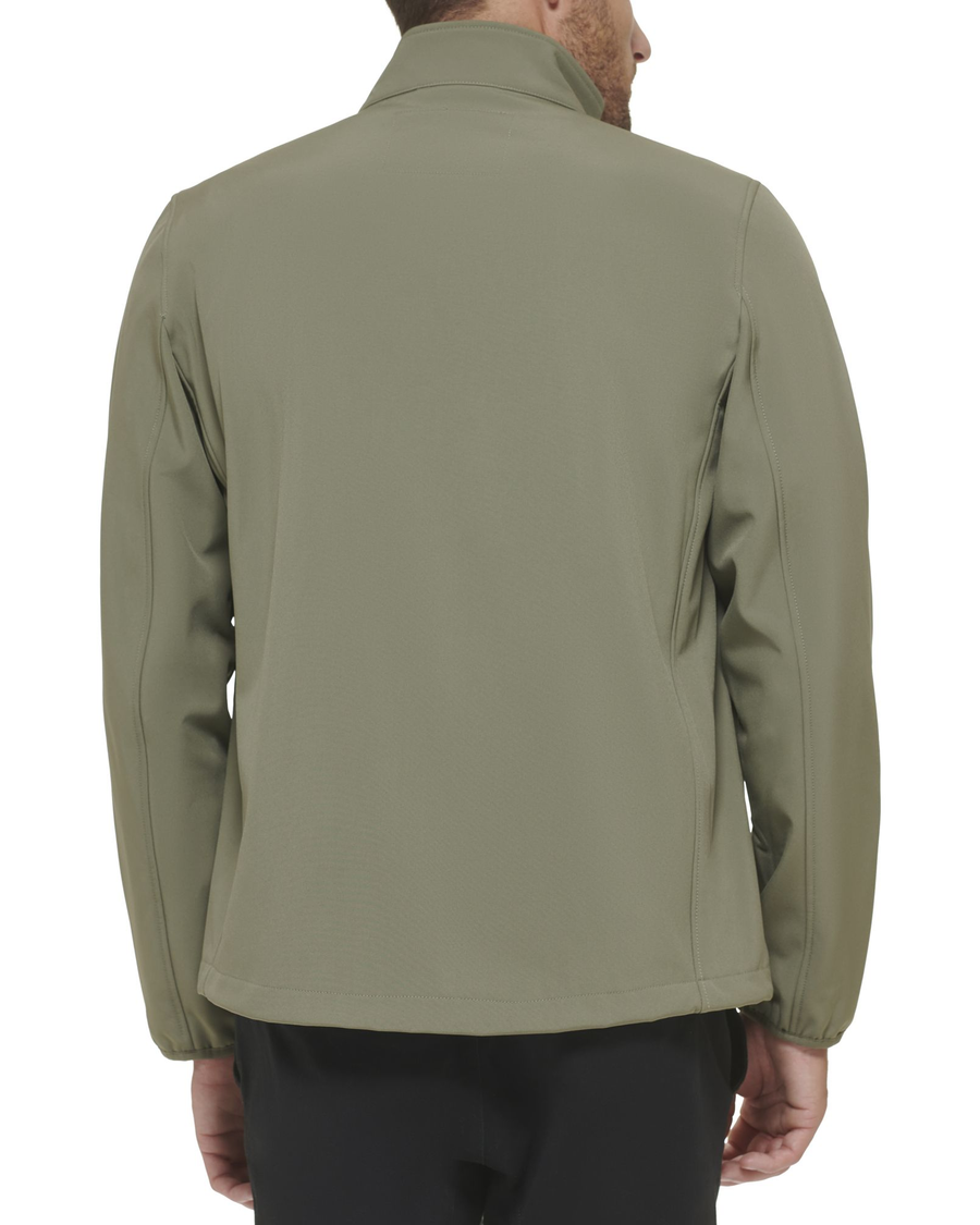 Back view of model wearing Olive Chest Yoke Softshell Jacket.
