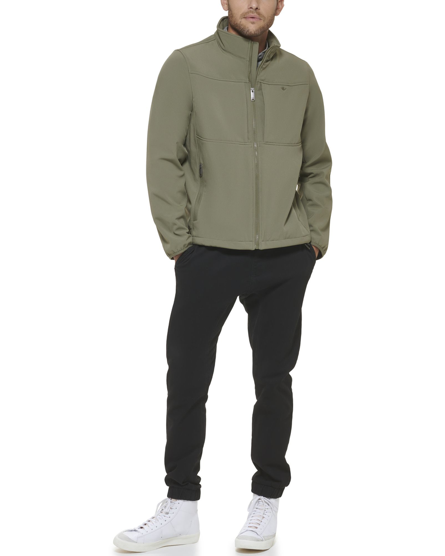Front view of model wearing Olive Chest Yoke Softshell Jacket.