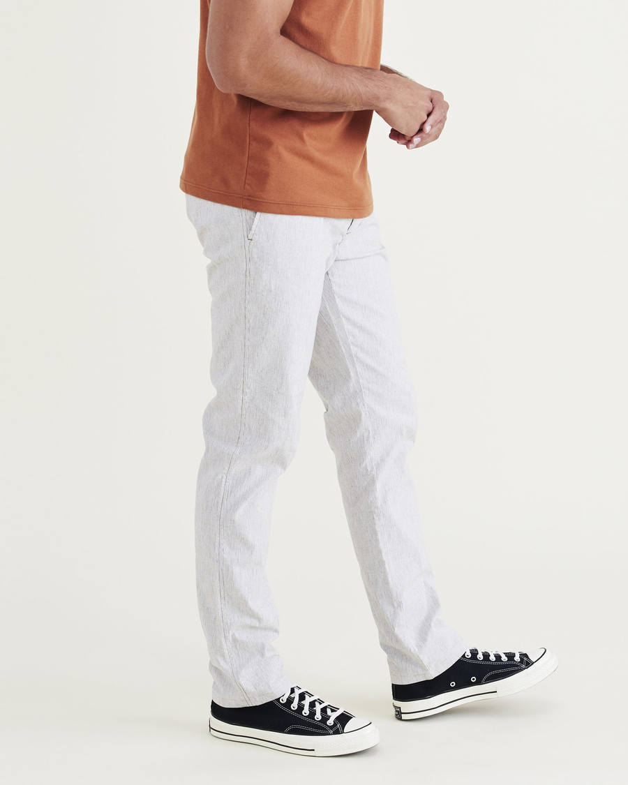 Side view of model wearing Otter Ultimate Chinos, Slim Fit.