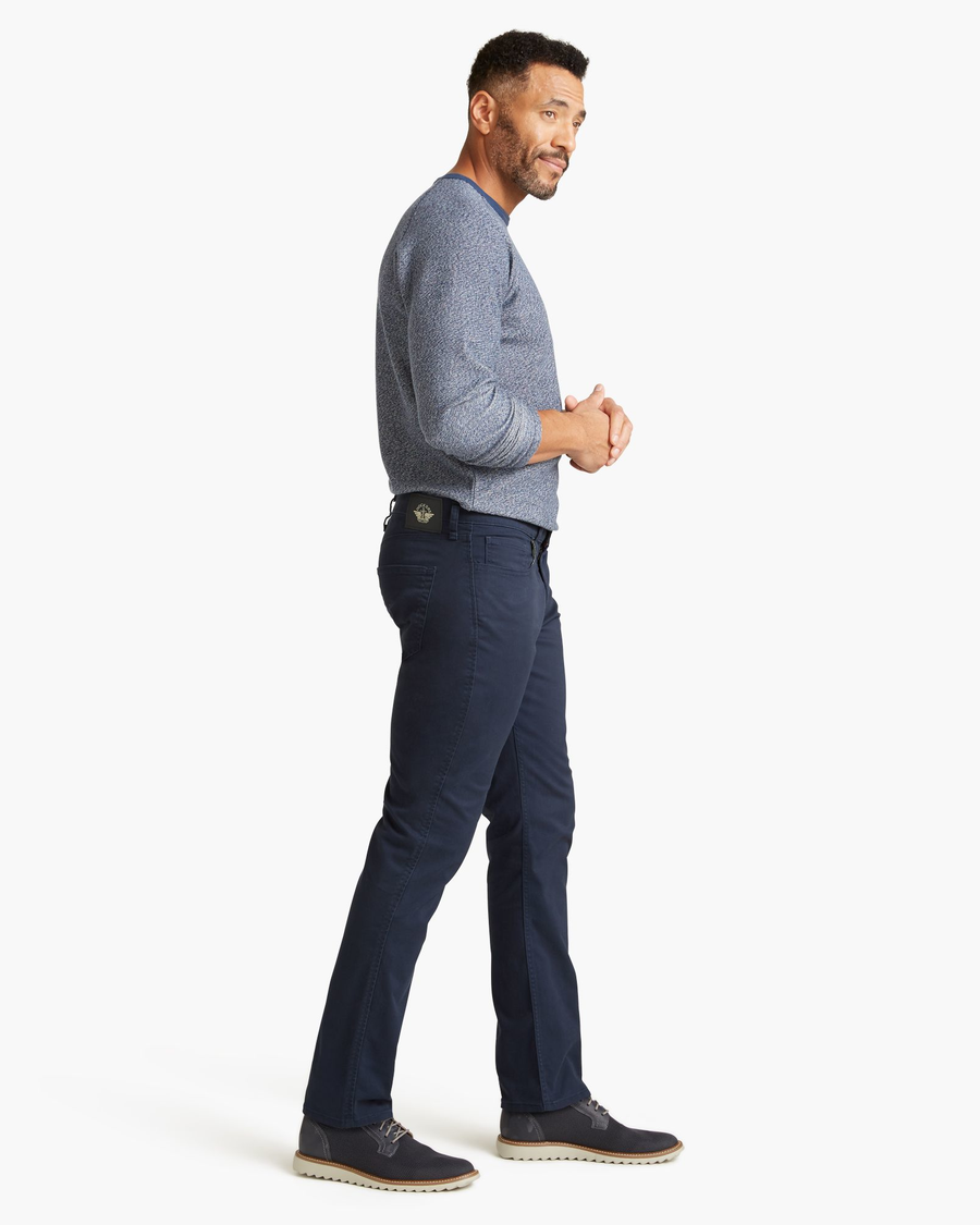 Side view of model wearing Pembroke Jean Cut Pants, Straight Fit.
