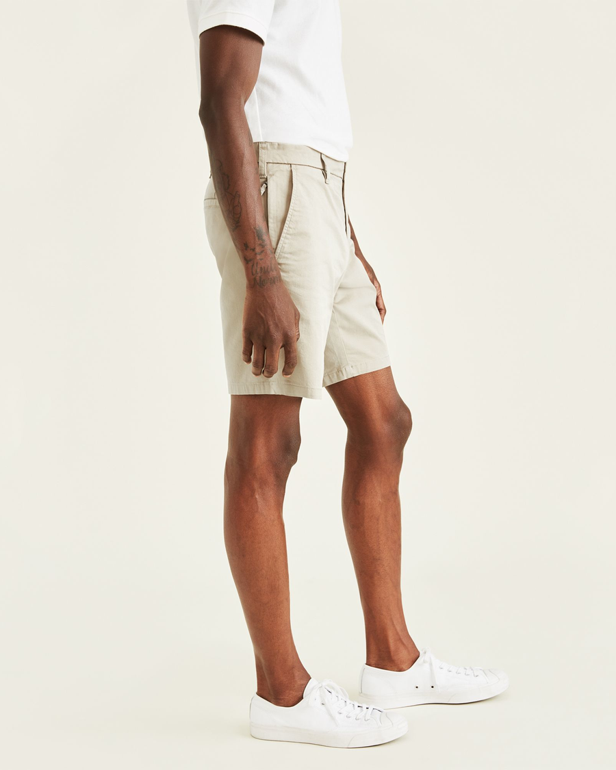 Side view of model wearing Porcelain Khaki Ultimate 9.5" Shorts.