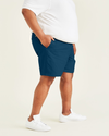 Side view of model wearing Poseidon Blue Ultimate 9.5" Shorts (Big and Tall).