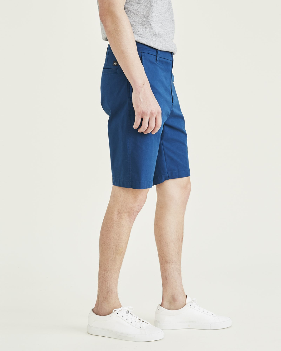 Side view of model wearing Poseidon Blue Ultimate 9.5" Shorts.