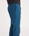 Side view of model wearing Poseidon Blue Ultimate Chino, Slim Fit.