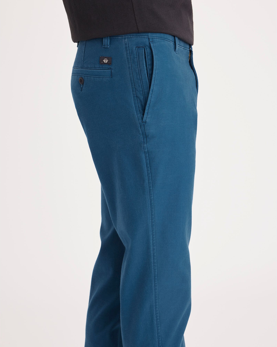 Side view of model wearing Poseidon Blue Ultimate Chino, Slim Fit.