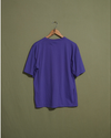 Back view of model wearing Purple Made in USA, Purple Embroidered Tee - M.