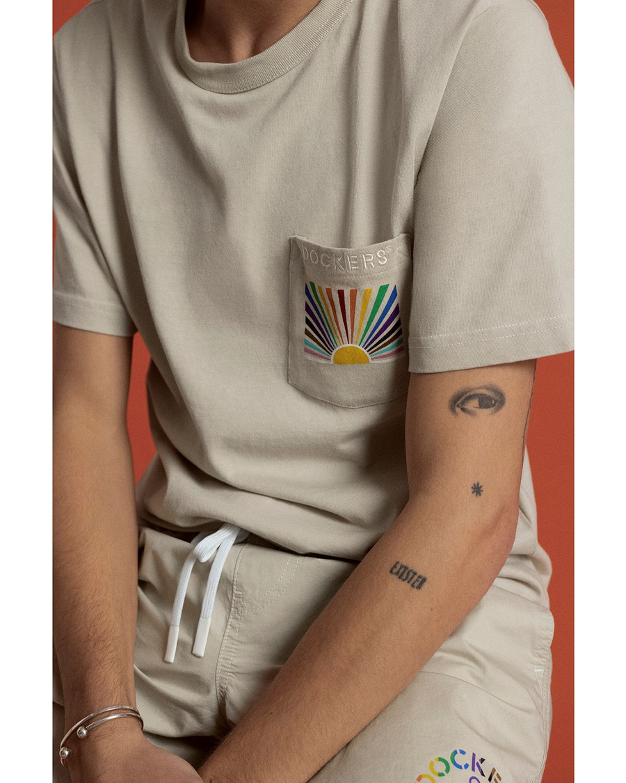 View of model wearing Rainbow Wave Pride Pocket Tee.