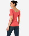 Back view of model wearing Rose Of Sharon Scoop Neck Tee Shirt.