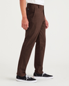 Side view of model wearing Shaved Chocolate Original Chinos, Slim Fit.