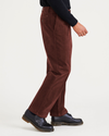 Side view of model wearing Shaved Chocolate Signature Khakis, Pleated, Relaxed Fit.