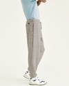Side view of model wearing Smokestack Heather Sport Sweatpants, Straight Fit.