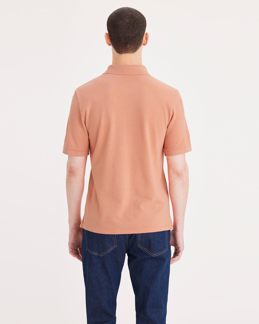 Back view of model wearing Tawny Orange Rib Collar Polo, Slim Fit.