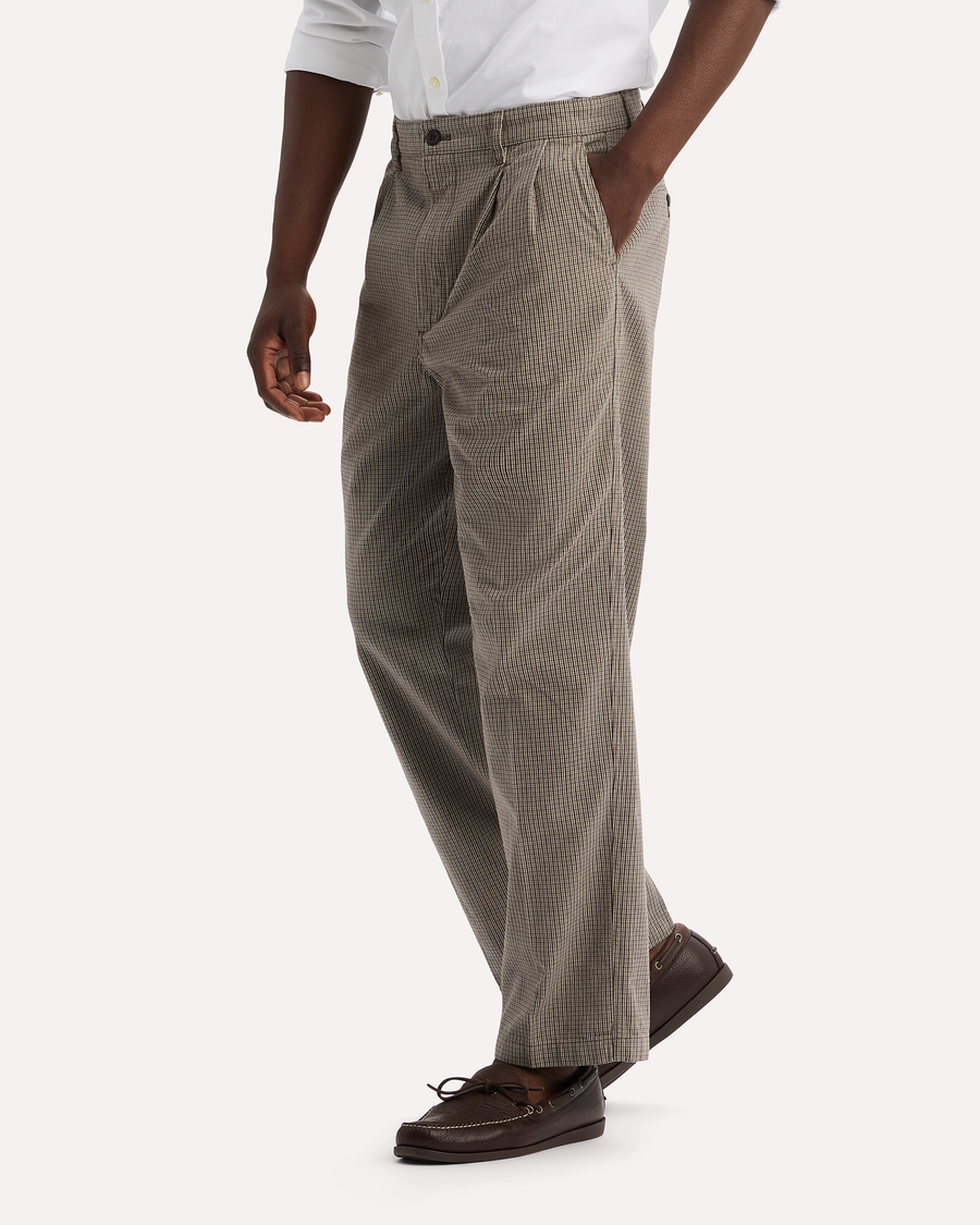 View of model wearing Thunderstorm Grey Eighty-Six Original Pleated Chinos, Loose Fit.