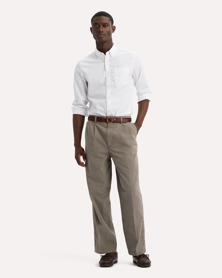 View of model wearing Thunderstorm Grey Eighty-Six Original Pleated Chinos, Loose Fit.