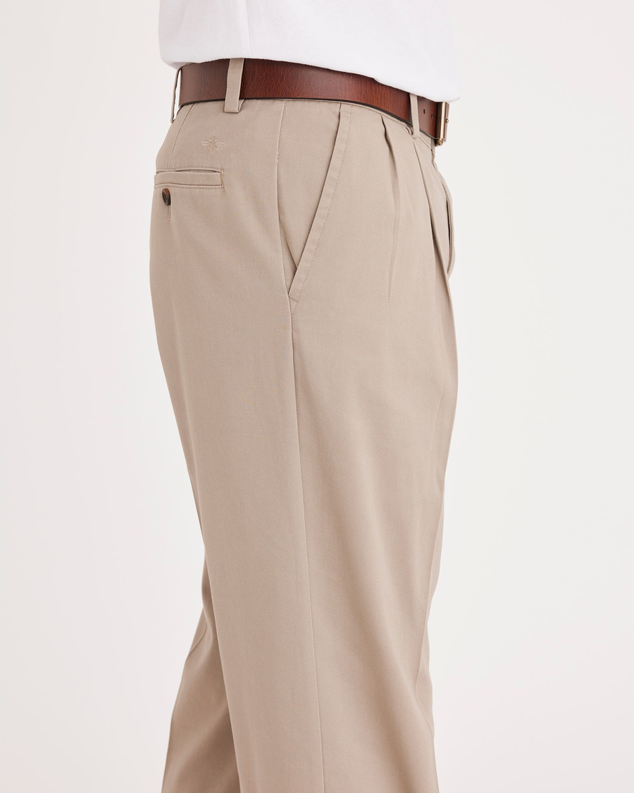 Side view of model wearing Timber Wolf Easy Khakis, Pleated, Classic Fit.