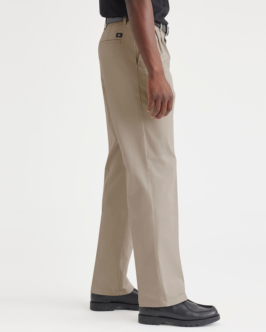 Side view of model wearing Timber Wolf Essential Chinos, Pleated, Classic Fit.
