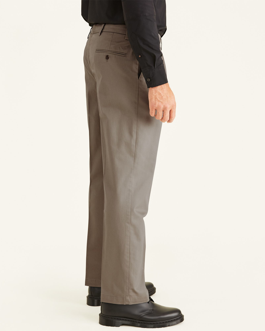 Side view of model wearing Timber Wolf Signature Khakis, Pleated, Classic Fit (Big and Tall).