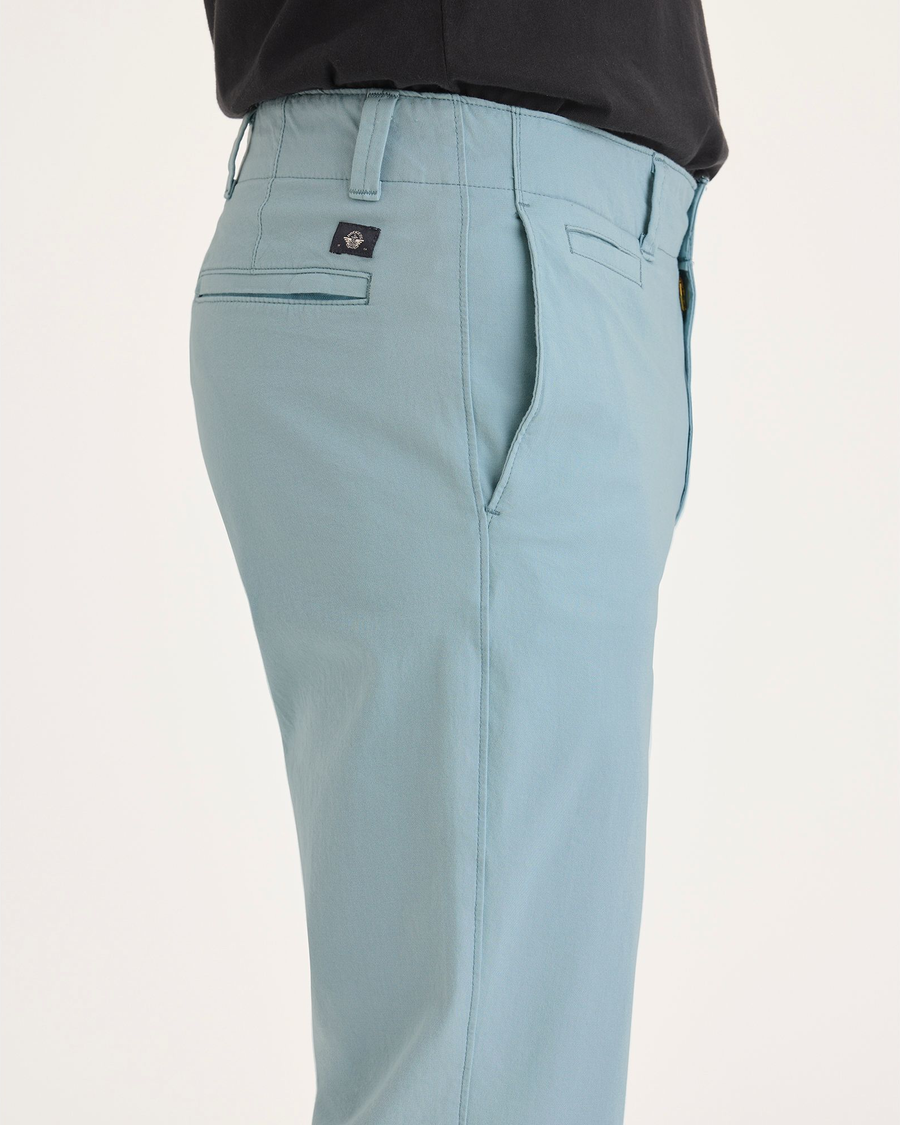 Side view of model wearing Tourmaline Alpha Chino, Slim Fit.