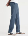 Side view of model wearing Vintage Indigo Ultimate Chinos, Athletic Fit.